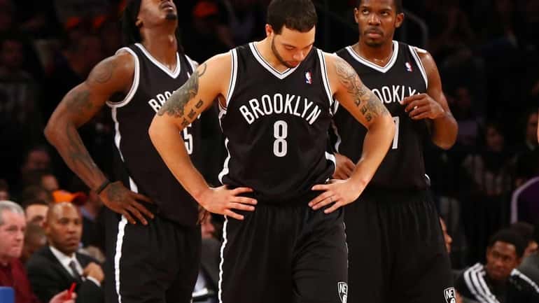 Deron Williams looks on in the second half of a...