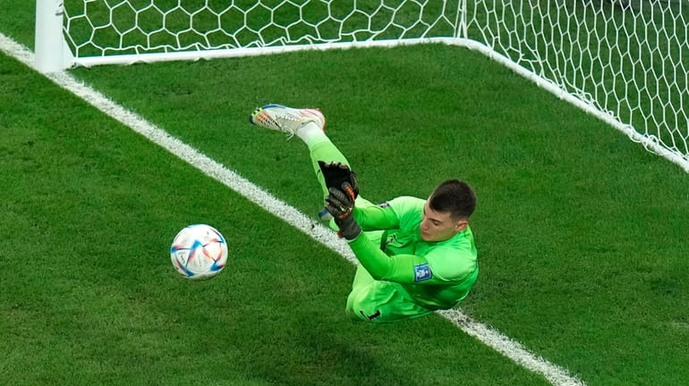 Croatia's goalkeeper Dominik Livakovic saves a ball during the penalty...