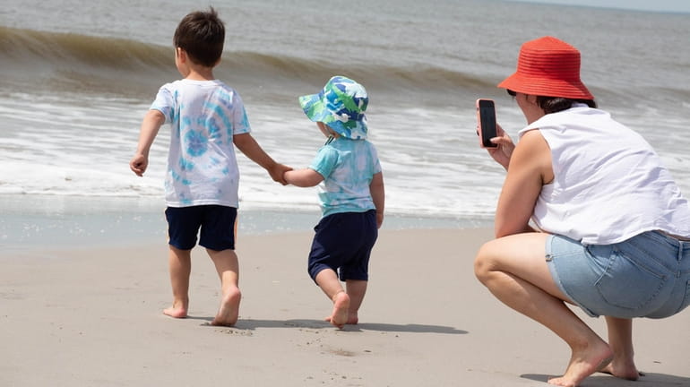 Carolyn Miller, of Lindenhurst, photographs her sons, Brodie, 3, and...