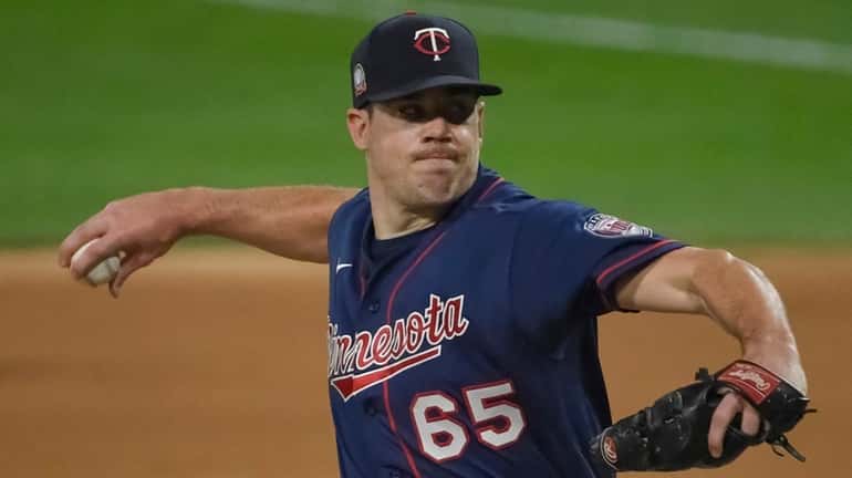 Trevor May of the Twins pitches in the ninth inning against...