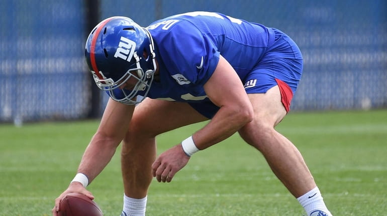Giants long snapper Zak DeOssie sets to snap the football...