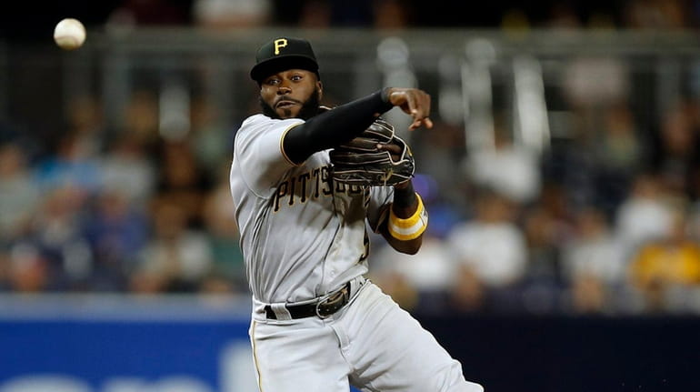 Pittsburgh Pirates second baseman Josh Harrison, above, forces out San...