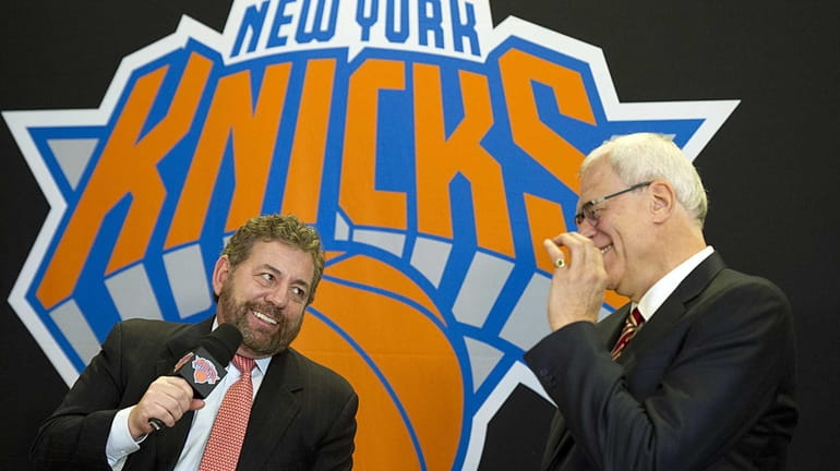 Knicks owner James Dolan, left, talks to the media with...