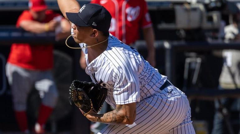 Yankees pitcher Jonathan Loaisiga throws in the top of the fourth inning...
