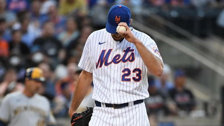 Mets starting pitcher David Peterson reacts on the mound against...