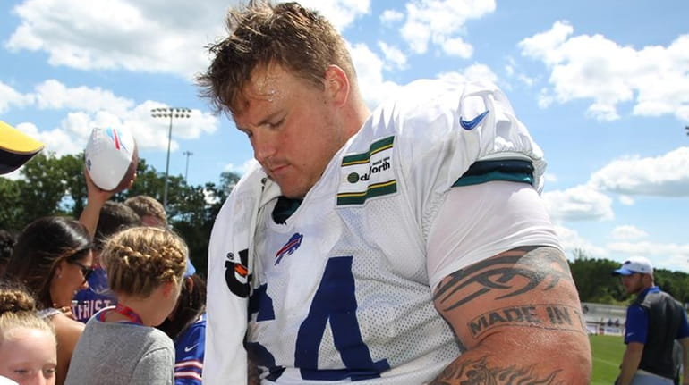Buffalo Bills guard Richie Incognito signs autographs during training camp...