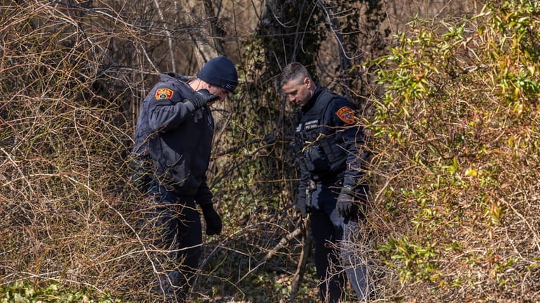 Suffolk Police investigators search Southards Pond Park in Babylon on Mar....