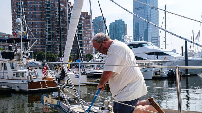 First-time skipper Brad Dickson, of Glen Cove, preps his boat...