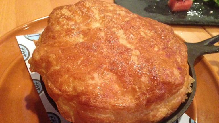 The homestyle chicken pot pie is served in a buttery...