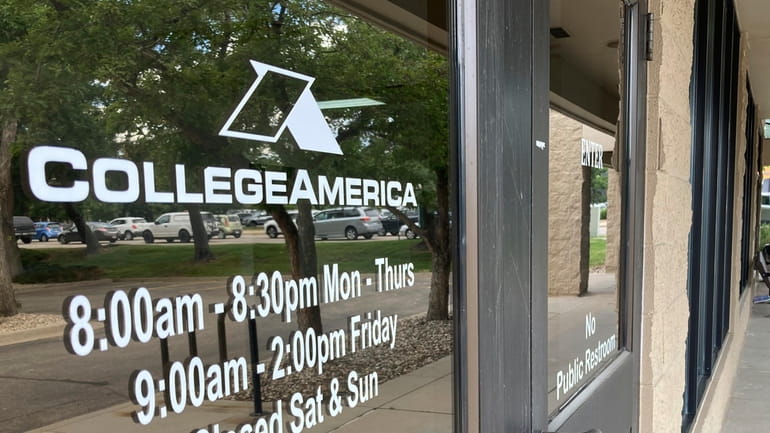 A CollegeAmerica sign is displayed on a window outside their...