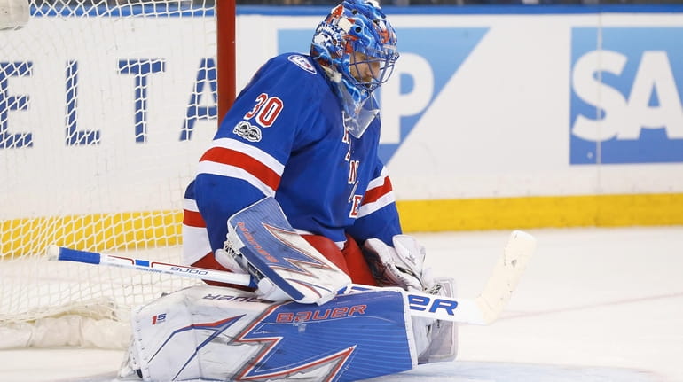 Henrik Lundqvist of the New York Rangers looks on after...