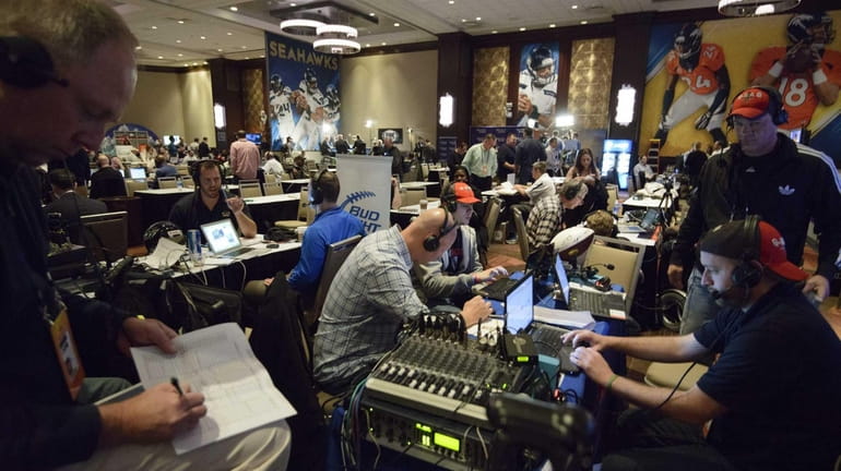 Members of the media broadcast from the "Radio Row" at...