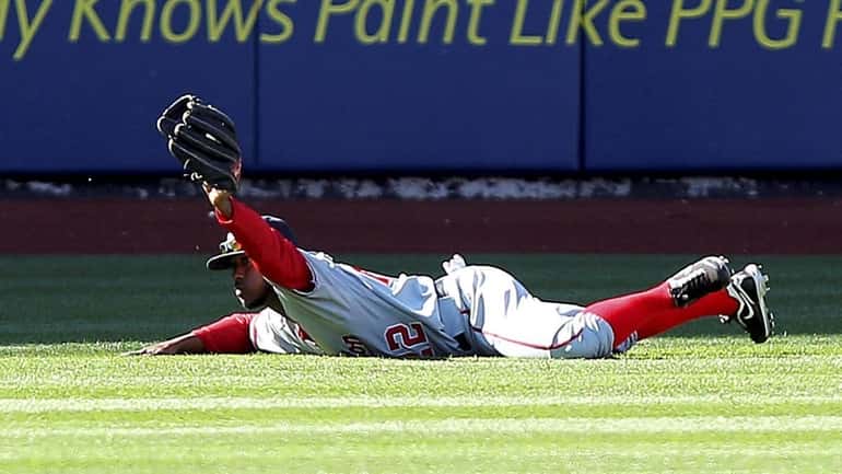 Washington Nationals Willie Harris reacts after making a diving catch...