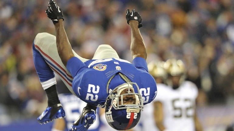 David Wilson of the Giants flips after returning a kickoff...
