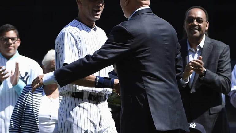 Yankees shortstop Derek Jeter greets Cal Ripken Jr. on Derek...