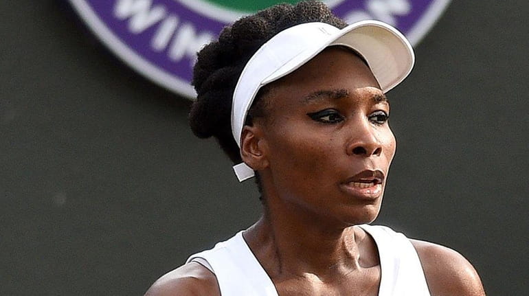 Venus Williams reacts against Naomi Osaka at Wimbledon on July...