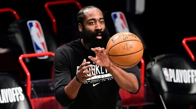 James Harden #13 of the Nets warms up prior to...