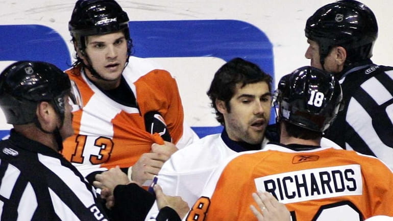 Philadelphia's Dan Carcillo, rear, looks on as Islanders goalie Rick...