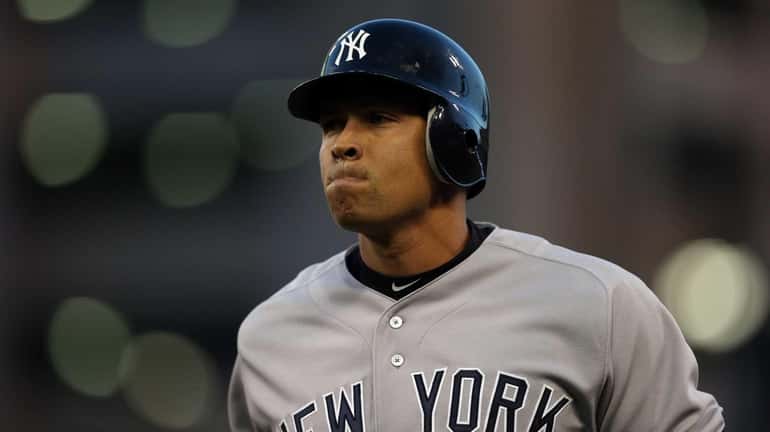 Alex Rodriguez reacts as he walks back to the dugout...