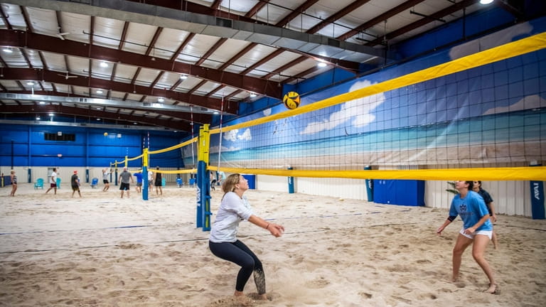 People play volleyball at North Beach, an indoor sand volleyball...