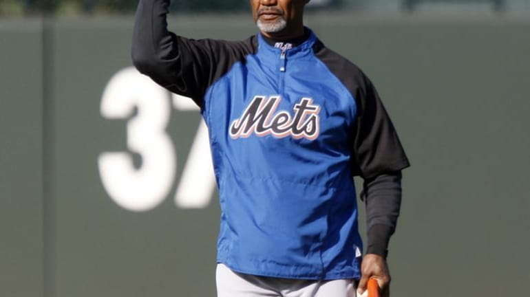 New York Mets manager Jerry Manuel throws a ball while...
