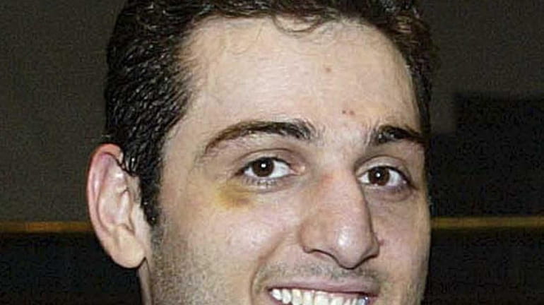 Tamerlan Tsarnaev smiles after accepting the trophy for winning the...