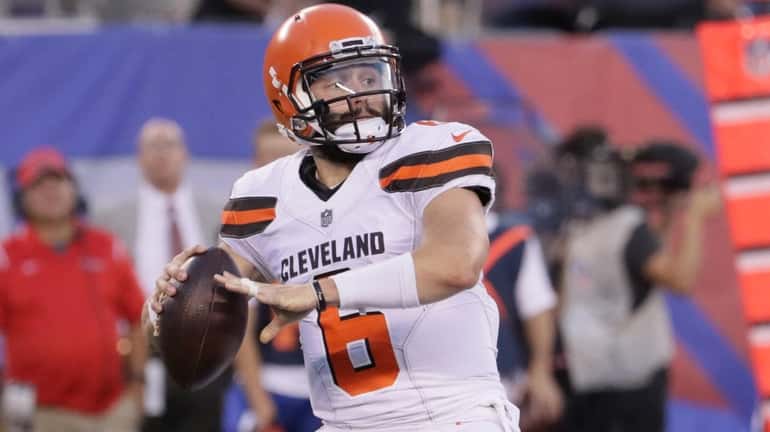 Browns quarterback Baker Mayfield releases a pass for a first...