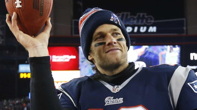 New England Patriots quarterback Tom Brady holds up the game...