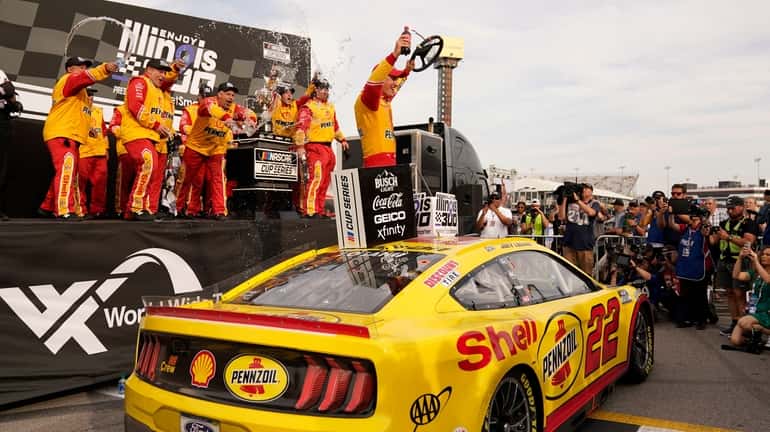 Joey Logano celebrates after winning a NASCAR Cup Series auto...