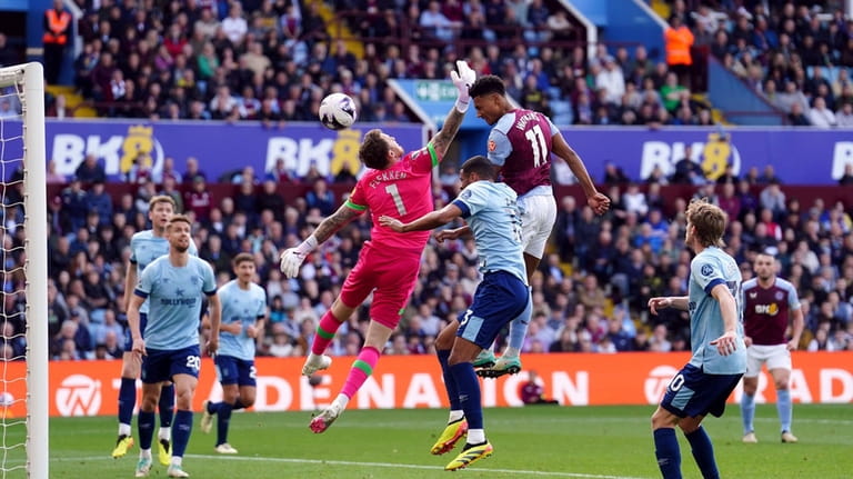Aston Villa's Ollie Watkins scores his side's third goal of...