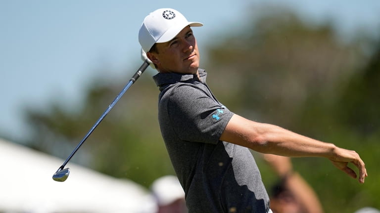 Jordan Spieth watches his tee shot on the third hole...