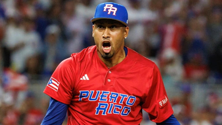 Puerto Rico pitcher Edwin Diaz reacts after striking out Dominican...