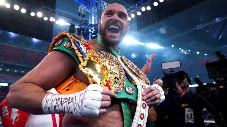 Tyson Fury celebrates after beating Dillian Whyte to win their...