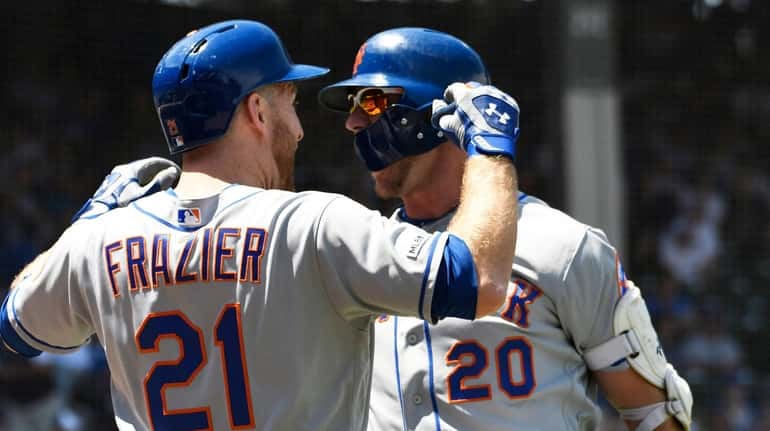 Pete Alonso, right, who hit his 26th home run Saturday,...