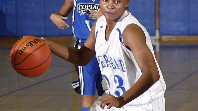 Riverhead's Shanice Allen (23) drives to the hoop from the...