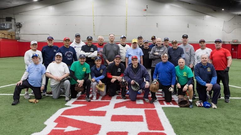 Members of the senior softball league pose for a group...