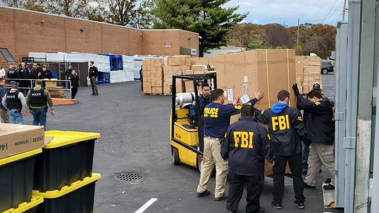 Authorities at the scene of an FBI raid of Aventura...