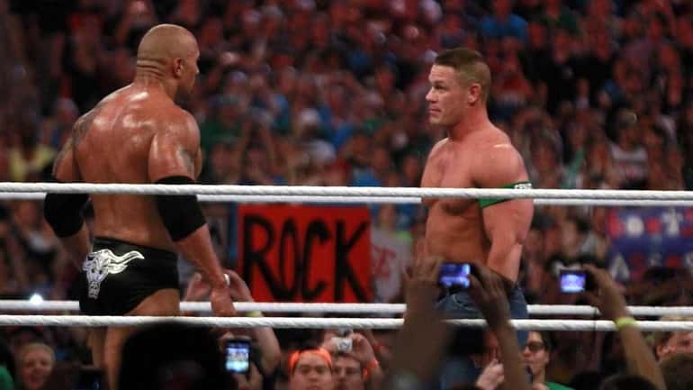 Dwyane 'The Rock' Johnson, left, and John Cena face off...
