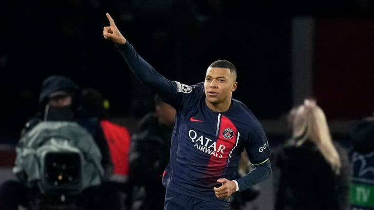PSG's Kylian Mbappe celebrates after scoring his side's first goal...