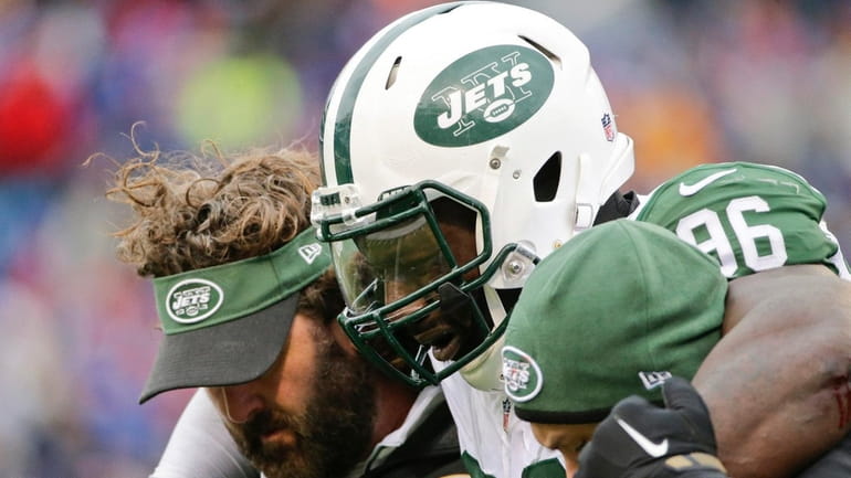 New York Jets defensive end Muhammad Wilkerson is helped off...