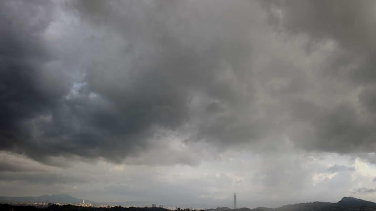 Dark clouds gather above Taipei as typhoon Muifa passes eastern...