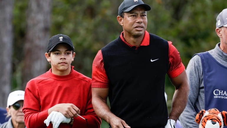 Tiger Woods, right, and his son Charlie Woods, left, prepare...