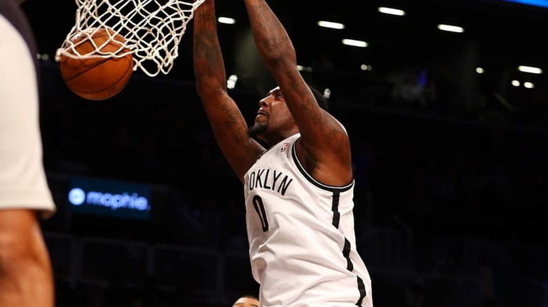 Andray Blatche dunks the ball in the first half of...