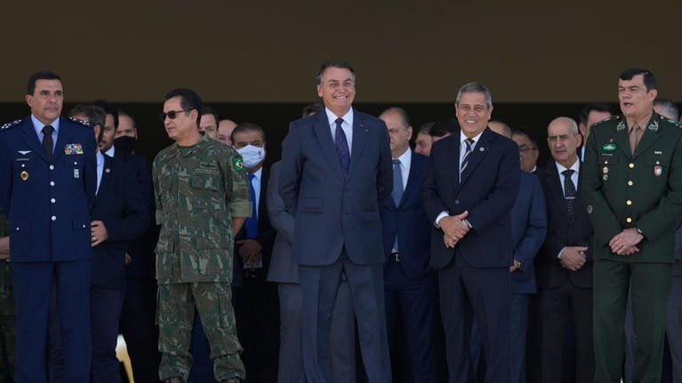 Brazilian President Jair Bolsonaro, center, and his Defense Minister Walter...