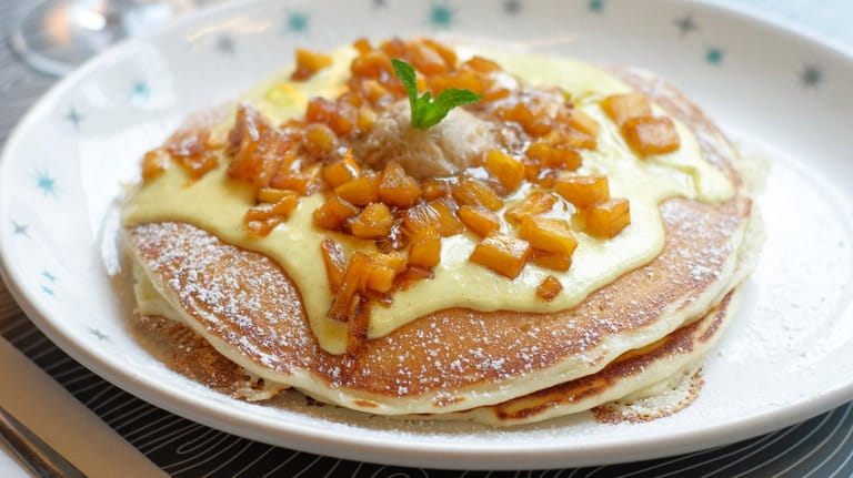 Pineapple upside down pancakes are topped with house-made vanilla rum...