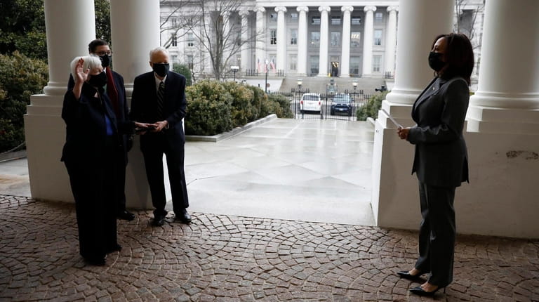 Treasury Secretary Janet Yellen is sworn in by Vice President Kamala Harris...