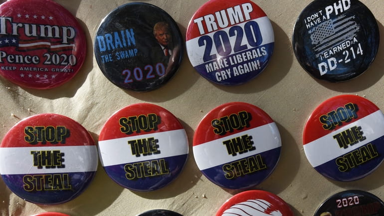 "Stop the Steal" badges for sale outside the 2021 Conservative...