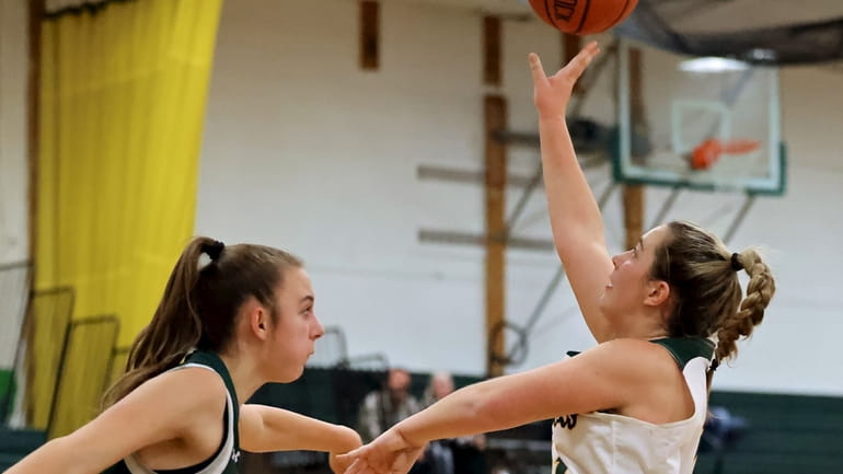 Ward Melville guard Grace Balocca goes for the the layup over...