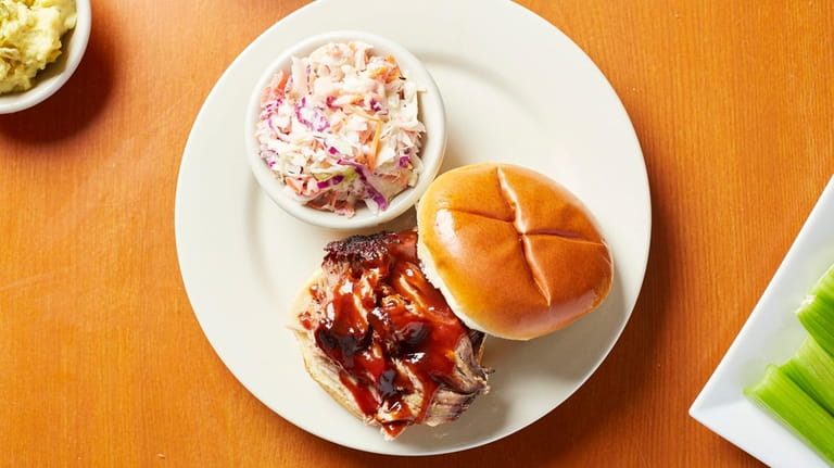 A pulled pork sandwich with coleslaw at Laura's BBQ in...