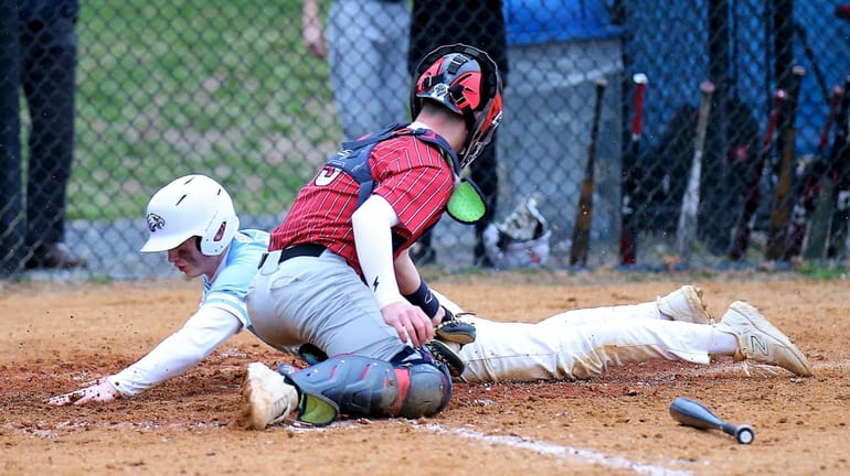 Rocky Point's Jeremy Graham slides safely into home with the...